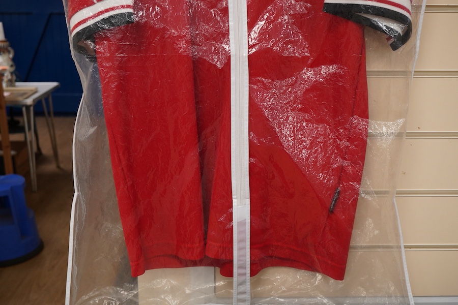 A Manchester United Umbro Sharp polo shirt, signed by David Beckham